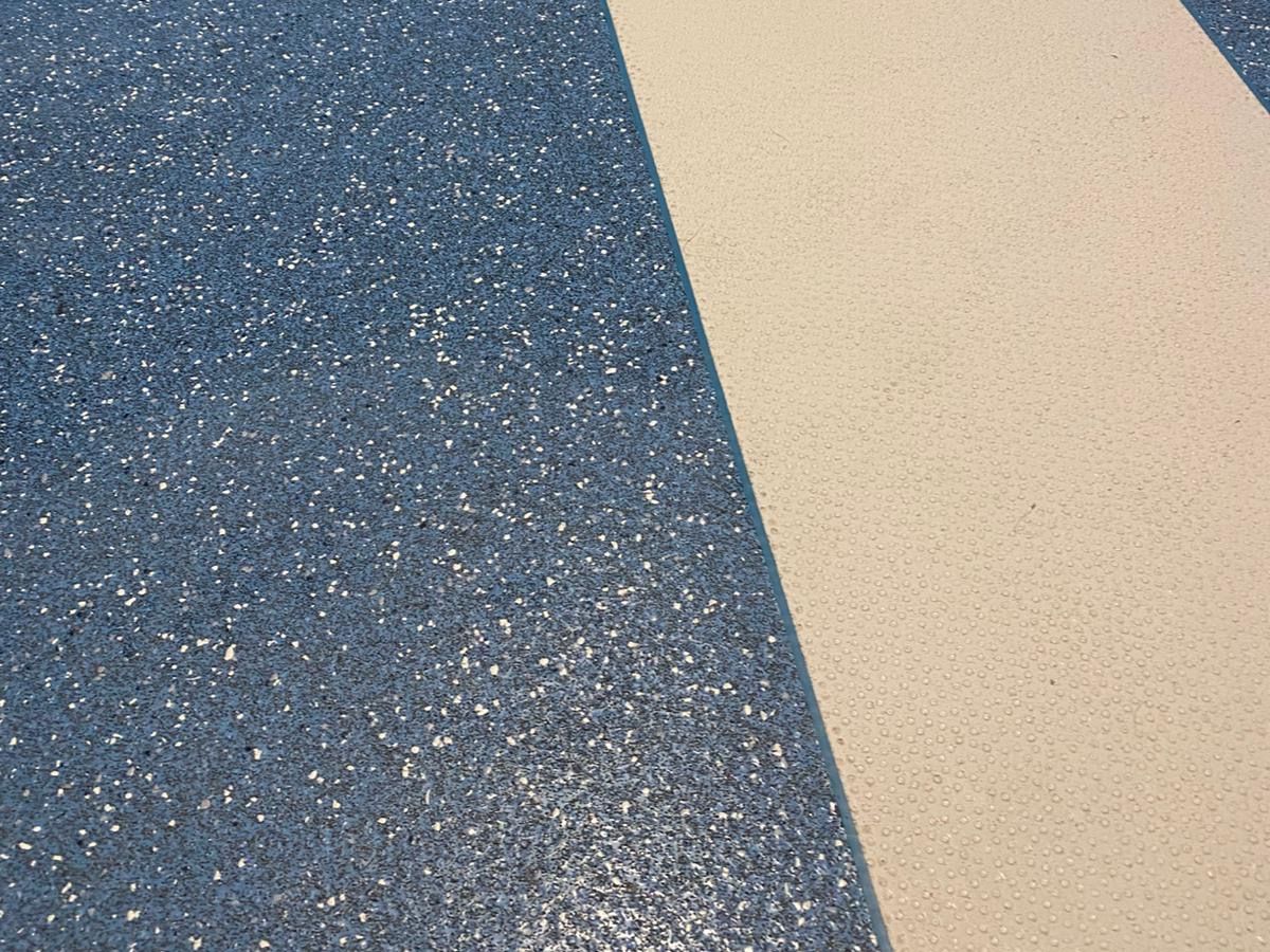 Close-up of blue speckled safety vinyl with a cream inset strip