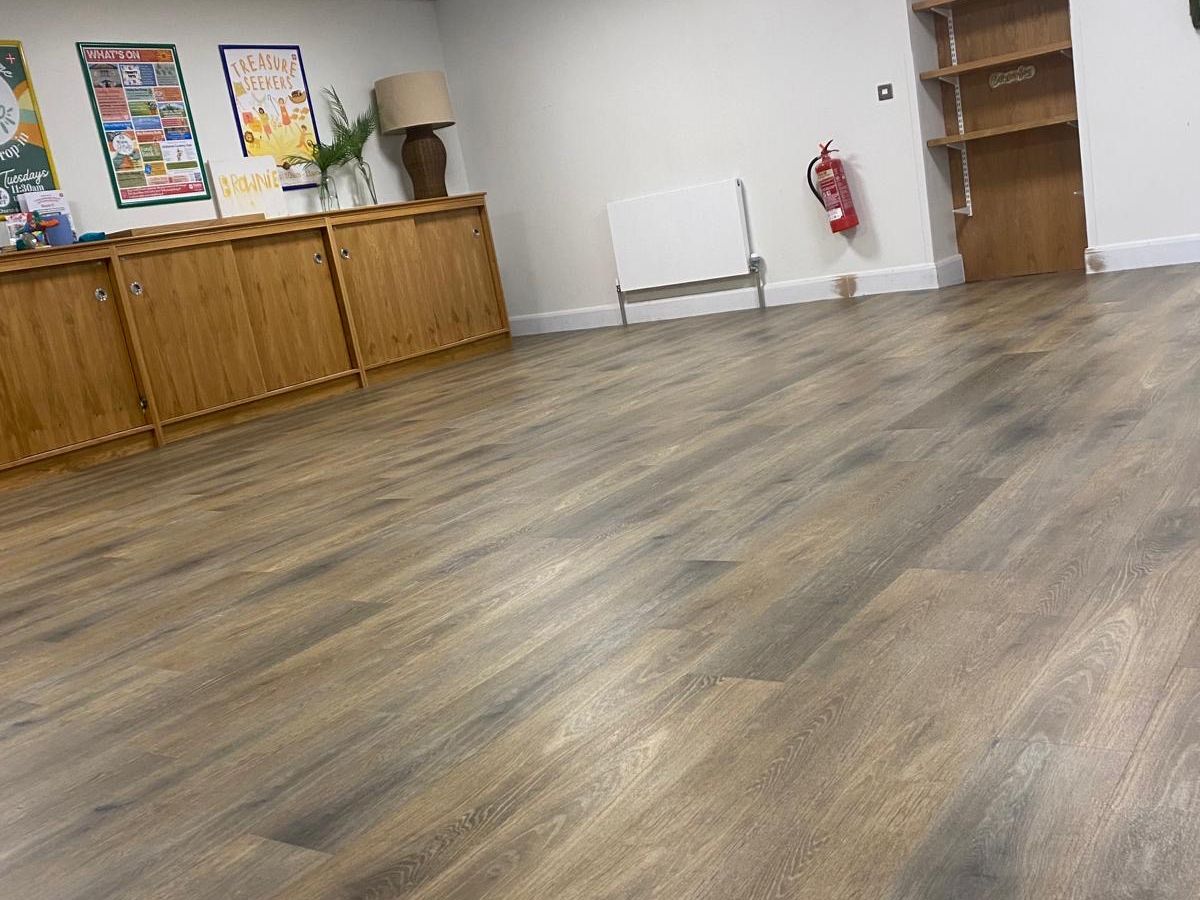 Large room with wood-effect vinyl flooring laid throughout